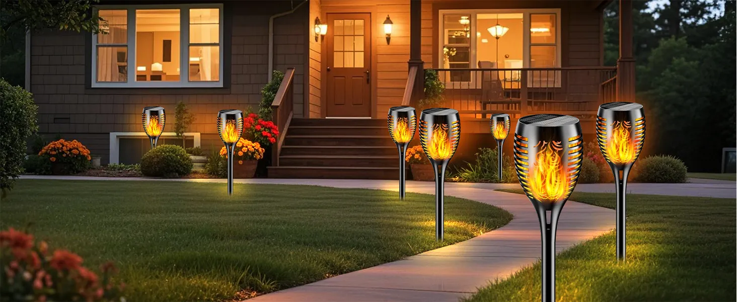 Realistic flame solar torch lighting up a driveway during evening