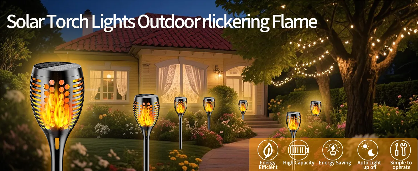 Decorative solar torch lights with flickering flame effect illuminating a garden pathway at dusk.