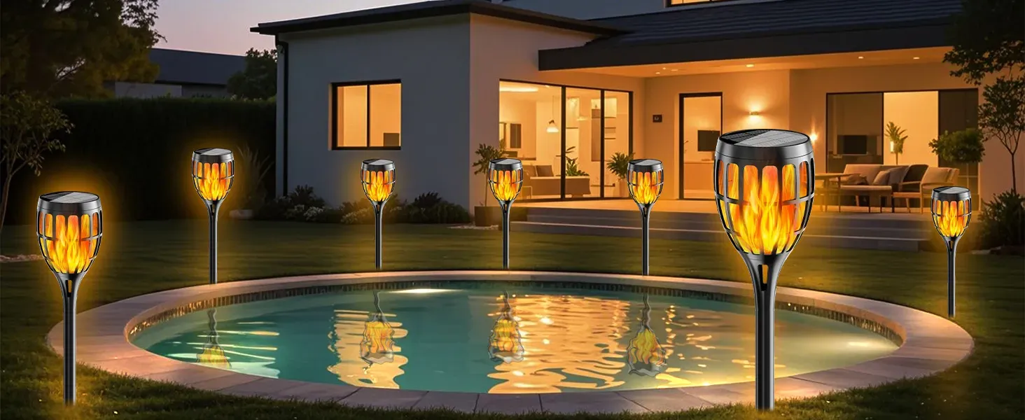 Close-up of solar torch light with flickering flame effect at night